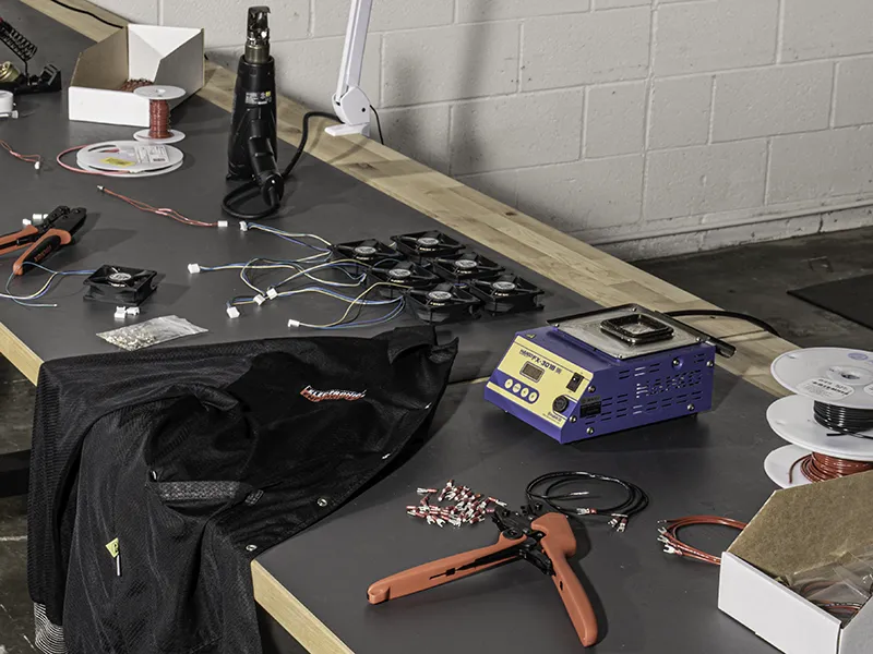 Fan and wire termination on conductive silicone bench in ESD safe area.